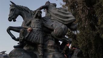 Boys play on the Salah Al Din Statue after Syria's Bashar al-Assad was ousted, in Damascus, Syria, December 25, 2024. Reuters
