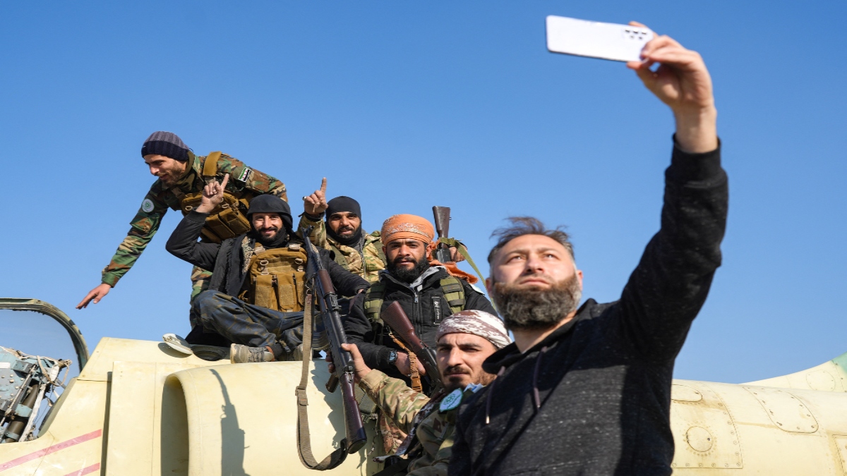 Anti-government fighters pose for a selfie on a Syrian regime military aircraft at the Kweyris military airfield in the eastern part of Aleppo province on Tuesday. AFP Anti-government fighters pose for a selfie on a Syrian regime military aircraft at the Kweyris military airfield in the eastern part of Aleppo province on Tuesday. AFP