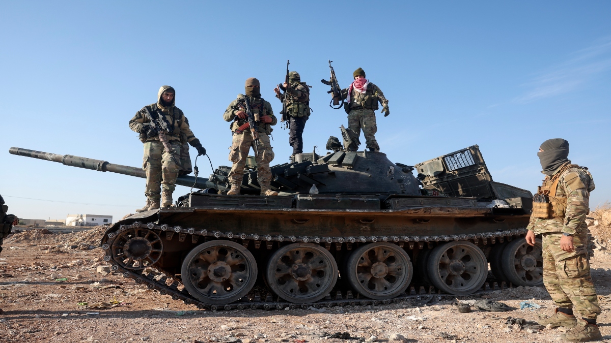 Syrian opposition fighters stand atop a seized military armored vehicle on the outskirts of Hama, Syria, on Tuesday. AP  Syrian opposition fighters stand atop a seized military armored vehicle on the outskirts of Hama, Syria, on Tuesday. AP