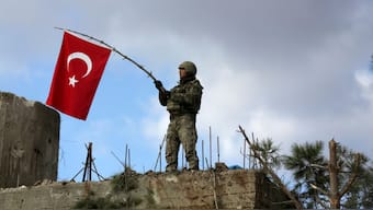 A Turkish soldier waves a flag on Mount Barsaya, northeast of Afrin, Syria. Image used for representative purpose/Reuters