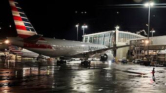 FILE PHOTO: An American Airlines plane sits at a gate at Logan Airport. Reuters