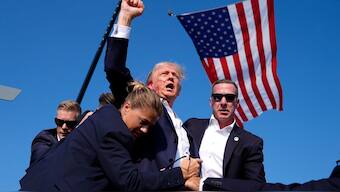 Sean Curran and Secret service agents surround Donald Trump after an assassination attempt at a campaign rally in Butler, Pennsylvania in July. File Image / AP