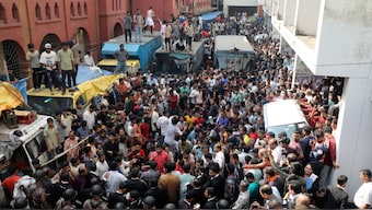 Supporters of the Hindu priest surround the van after a court ordered him detained pending further proceedings in southeastern Bangladesh, November 26, 2024. AP
