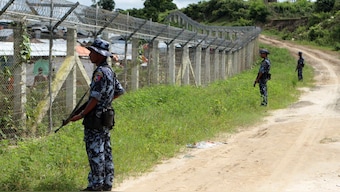 Myanmar border guards stand to provide security near the fence at a no-man's land between Myanmar and Bangladesh, near Taungpyolatyar village, Maungdaw, northern Rakhine State, Myanmar, on June 29, 2018. AP