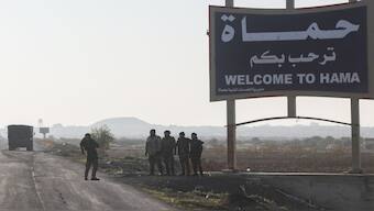 Syrian opposition fighters take pictures in the outskirts of of Hama, Syria, Tuesday December 3. AP