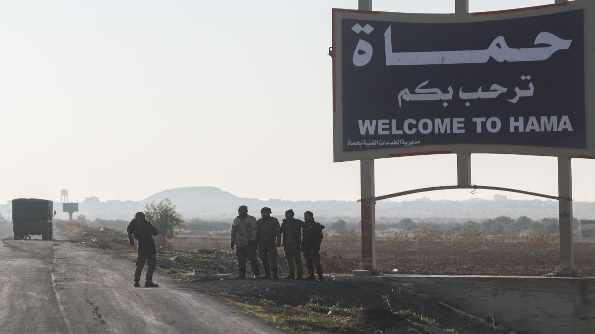 Syrian opposition fighters take pictures in the outskirts of of Hama, Syria, Tuesday December 3. AP Syrian opposition fighters take pictures in the outskirts of of Hama, Syria, Tuesday December 3. AP