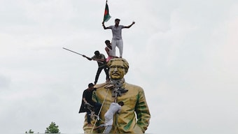 People climb the statue of Sheikh Mujibur Rahman at the Bijoy Sarani area, as they celebrate the resignation of the Prime Minister Sheikh Hasina in Dhaka, Bangladesh on August 5. File image/AFP