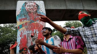 Protesters shout slogans as they vandalise a mural of Bangladesh's Sheikh Hasina with paint and mud, demanding her resignation at the University of Dhaka in Dhaka, Bangladesh, on August 3. Two days on, Hasina stepped down as PM and fled to India. File photo/Reuters