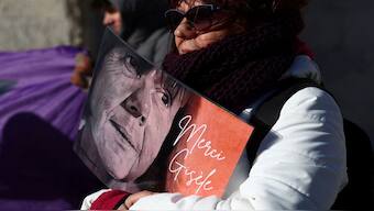 A woman holds a placard with a portrait of Gisele Pelicot during a gathering in support of the Frenchwoman, who was the victim of a mass rape orchestrated by her then-husband Dominique Pelicot at their home in the southern French town of Mazan, the day after the verdict in the trial for Dominique Pelicot and 50 co-accused, in front of the courthouse in Avignon, France. The slogan reads 'Thank you Gisele'. Reuters