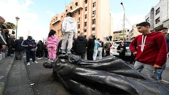 Children step on a toppled statue of former president Hafez al-Assad as people gather on a street in Sweida on December 13,  to celebrate the collapse of his son Bashar al-Assad's rule. Islamist-led rebels took Damascus in a lightning offensive on December 8, ousting president Bashar al-Assad and ending five decades of Baath rule in Syria. AFP/Representational image