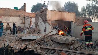 Firefighters pictured during the fire extinguishing operation at the Industrial Estate in Multan on January 27, 2024, in this still taken from a video. X