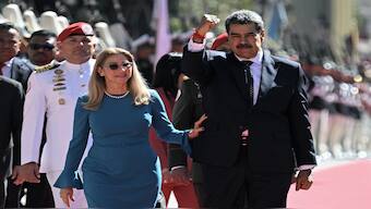 Venezuela's President Nicolas Maduro (R) gestures next to First Lady Cilia Flores on arrival at the Capitolio -house of the National Assembly- for the presidential inauguration, in Caracas on January 10, 2025. AFP
