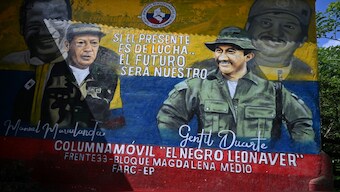 A mural with the images of Revolutionary Armed Forces of Colombia (FARC) late leader and founder Manuel Marulanda Velez (L) and Miguel Botache Santillana, alias Gentil Duarte, late leader of one of the structures of the dissidence of the extinct FARC, is seen in Teorama municipality, Catatumbo region, Norte de Santander department, Colombia, on January 23, 2025. AFP