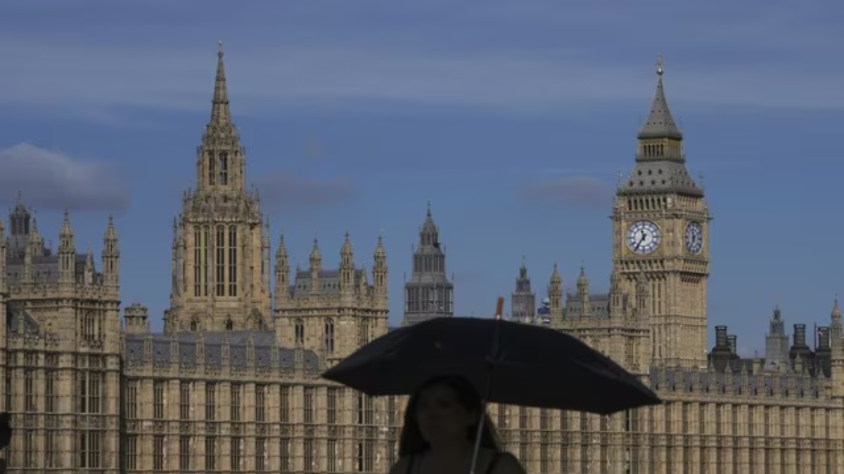 A woman walks past the UK Parliament in London on 11 September, 2024. File Image: AP A woman walks past the UK Parliament in London on 11 September, 2024. File Image: AP