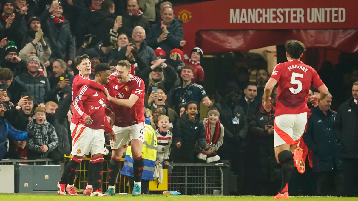 Manchester United players celebrate Amad Diallo's third goal in stoppage time during their Premier League match against Southampton at the Old Trafford Stadium, Manchester. AP Manchester United players celebrate Amad Diallo's third goal in stoppage time during their Premier League match against Southampton at the Old Trafford Stadium, Manchester. AP