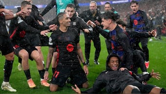 Barcelona's Raphina celebrates with teammates after scoring the winner in the UEFA Champions League match against Benfica in Lisbon. AP