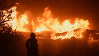 A firefighter works to extinguish flames as the Eaton Fire burns in Pasadena, California, US, on Wednesday. Reuters