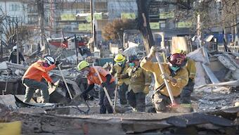Rescue personnel look for hazards and remains at the site of a burned building during the Eaton fire in Altadena, California, US, on Tuesday. Reuters