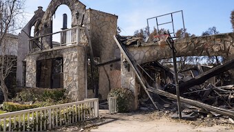 A basketball is stuck in the net outside of a residence destroyed by the Palisades Fire in the Pacific Palisades neighborhood of Los Angeles. AP