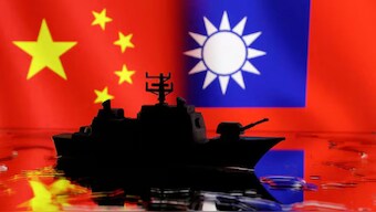 A Navy miniature is seen in front of displayed Chinese and Taiwanese flags in this illustration. Reuters