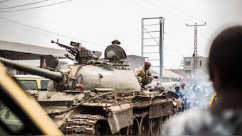 Soldiers of the Armed forces of the Democratic republic of Congo (FARDC) ride on top of a tank as they leave the city of Goma, on January 23, 2025 towards Sake. AFP