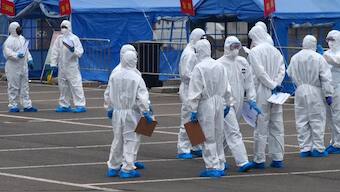 Chinese government workers coordinate transport of travellers from Wuhan to designated quarantine sites in Beijing. (Photo: AP)