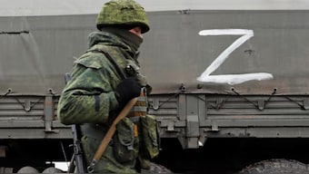 A serviceman of pro-Russian militia walks nest to a military convoy of armed forces of the separatist self-proclaimed Luhansk People's Republic (LNR) on a road in the Luhansk region, Ukraine February 27, 2022. (Photo: Reuters) 