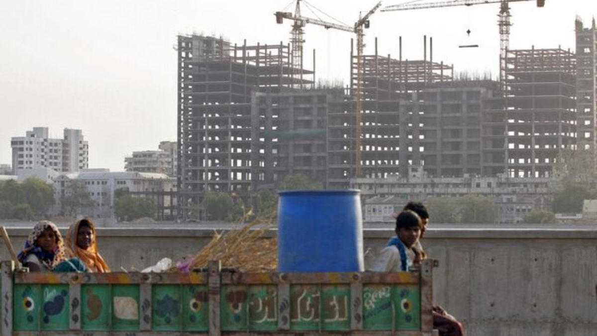 Labourers travel in a tractor trolley past hospital buildings under construction, after finishing their day's work, in Ahmedabad, India, May 27, 2015. (Photo: Reuters) Labourers travel in a tractor trolley past hospital buildings under construction, after finishing their day's work, in Ahmedabad, India, May 27, 2015. (Photo: Reuters)