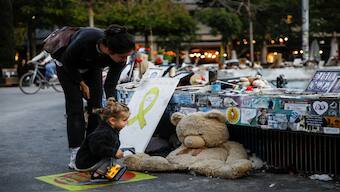 A woman and a child look at pictures and memorabilia related to fallen soldiers, hostages and people killed during the October 7, 2023 attack by Hamas, ahead of a ceasefire between Israel and Hamas, at a public square in Tel Aviv, Israel, on Thursday. Reuters