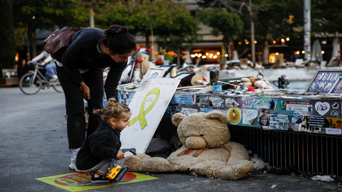 A woman and a child look at pictures and memorabilia related to fallen soldiers, hostages and people killed during the October 7, 2023 attack by Hamas, ahead of a ceasefire between Israel and Hamas, at a public square in Tel Aviv, Israel, on Thursday. Reuters A woman and a child look at pictures and memorabilia related to fallen soldiers, hostages and people killed during the October 7, 2023 attack by Hamas, ahead of a ceasefire between Israel and Hamas, at a public square in Tel Aviv, Israel, on Thursday. Reuters