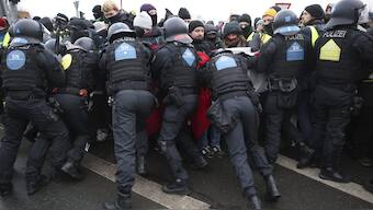 Police officers react with protestors to stop a demonstration against the AfD's national party conference, in Riesa, Germany. AP