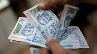 A man counting Rs 100 notes. Source: Reuters. 