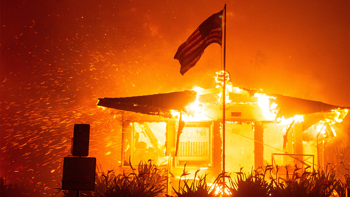 A US flag flies as fire engulfs a structure while the Palisades Fire burns during a windstorm on the west side of Los Angeles, California, US on January 7, 2025. Reuters A US flag flies as fire engulfs a structure while the Palisades Fire burns during a windstorm on the west side of Los Angeles, California, US on January 7, 2025. Reuters