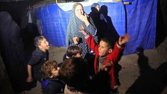 Palestinians celebrate at their camp for people displaced by conflict at Deir el-Balah in the central Gaza Strip, on January 15, 2025. AFP