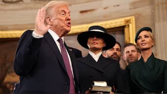 US President Donald Trump takes the oath to the office with wife Melania Trump by his side. Reuters