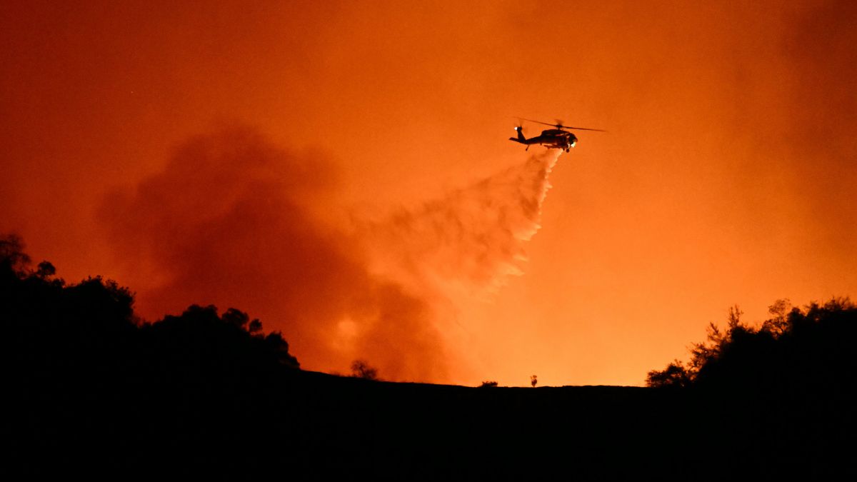 A helicopter drops water on smoke and flames from the Palisades Fire burning behind Mulholland drive towards the Encino neighborhood in Los Angeles, California, January 10, 2025. Image- AFP A helicopter drops water on smoke and flames from the Palisades Fire burning behind Mulholland drive towards the Encino neighborhood in Los Angeles, California, January 10, 2025. Image- AFP