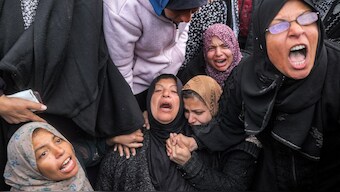 Women mourn their relatives who were killed by Israeli bombardment outside the Aqsa Martyrs hospital in Deir el-Balah in the central Gaza Strip on January 5. AFP