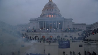 Police officers stand guard as supporters of President Trump gather in front of the Capitol Building. File Image- Reuters 