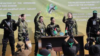 Israeli female soldier hostages wave at a Palestinian crowd before being handed over to the Red Cross in Gaza City, Saturday, Jan. 25, 2025.- Image- AP