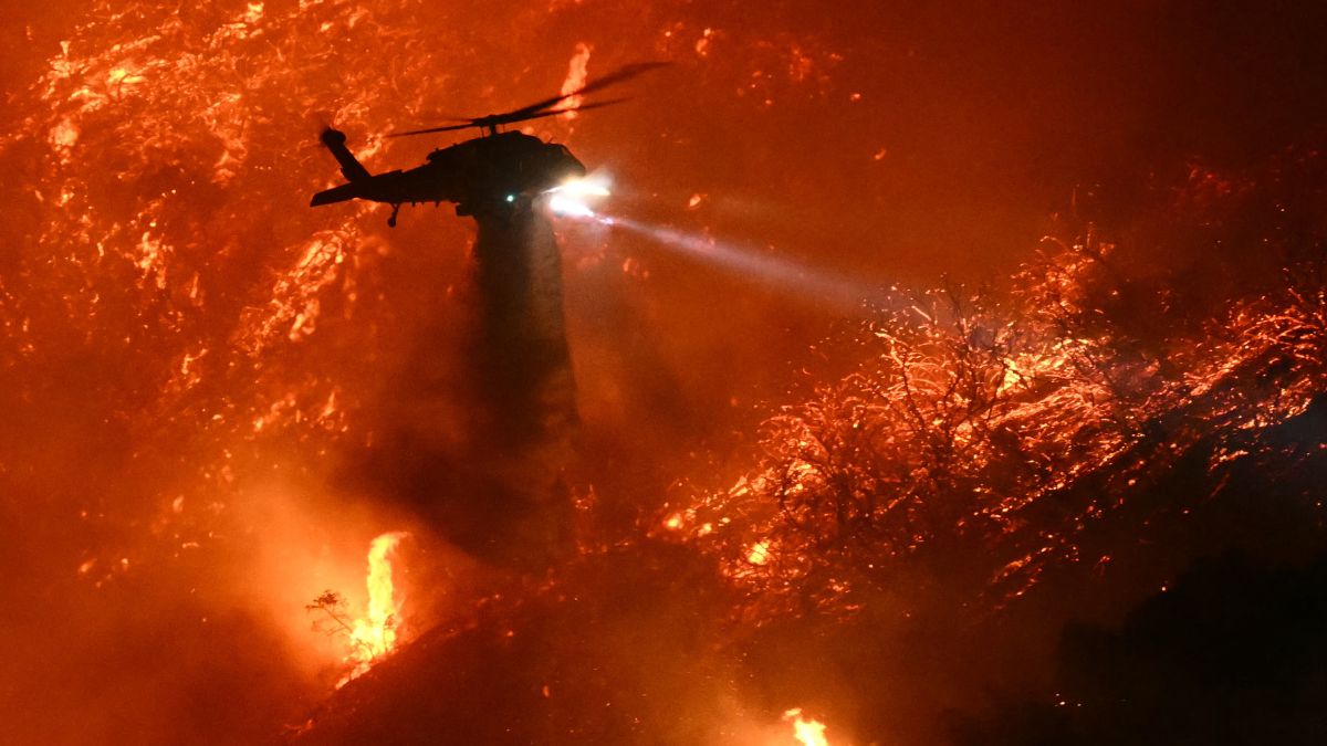 A fire fighting helicopter drops water as the Palisades fire grows near the Mandeville Canyon neighborhood and Encino, California, on January 11, 2025. Image- AFP A fire fighting helicopter drops water as the Palisades fire grows near the Mandeville Canyon neighborhood and Encino, California, on January 11, 2025. Image- AFP