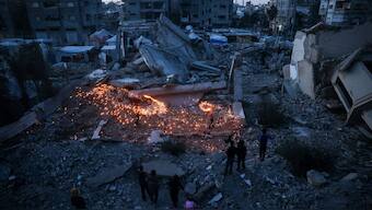 Children play with fireworks on the rubble of destroyed buildings at a camp for displaced Palestinians in Bureij in the central Gaza Strip on January 18, 2025, a day before a ceasefire is set to take effect following the Israeli cabinet's approval of a deal between Israel and Hamas.  Image- AFP