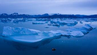 A boat navigates large icebergs near the town of Kulusuk, in eastern Greenland, File Image- AP