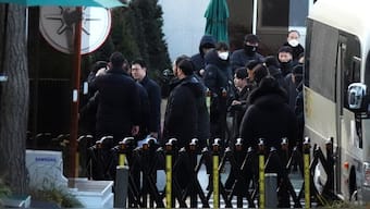 Investigators from the Corruption Investigation Office for High-ranking Officials arrive at the gate of the presidential residence as supporters of impeached South Korean President Yoon Suk Yeol stage a rally to oppose a court having issued a warrant to detain Yoon, in Seoul, South Korea, January 3, 2025. File Image/AP