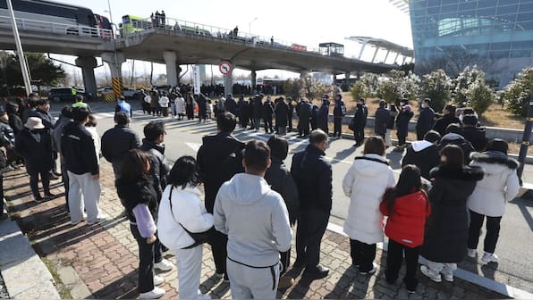 South Korea: Grieving relatives pay respects at crash site as search for answers continues