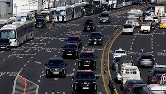 A motorcade believed to be carrying impeached South Korean President Yoon Suk Yeol following his arrest drives down a road, in Seoul, South Korea. Reuters