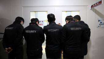 Airport security staff block the front door of the operations department during a police raid at Muan International Airport in Muan on January 2, 2025. Source: AFP | YONHAP. 