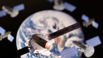 A satellite model is placed on a picture of Earth in this illustration. File image/ Reuters