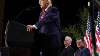 Rep. Tom Emmer, R-Minn., and House Speaker Mike Johnson of La., listen as President Donald Trump speaks at the 2025 House Republican Members Conference dinner at Trump National Doral Miami in Doral, Fla. AP