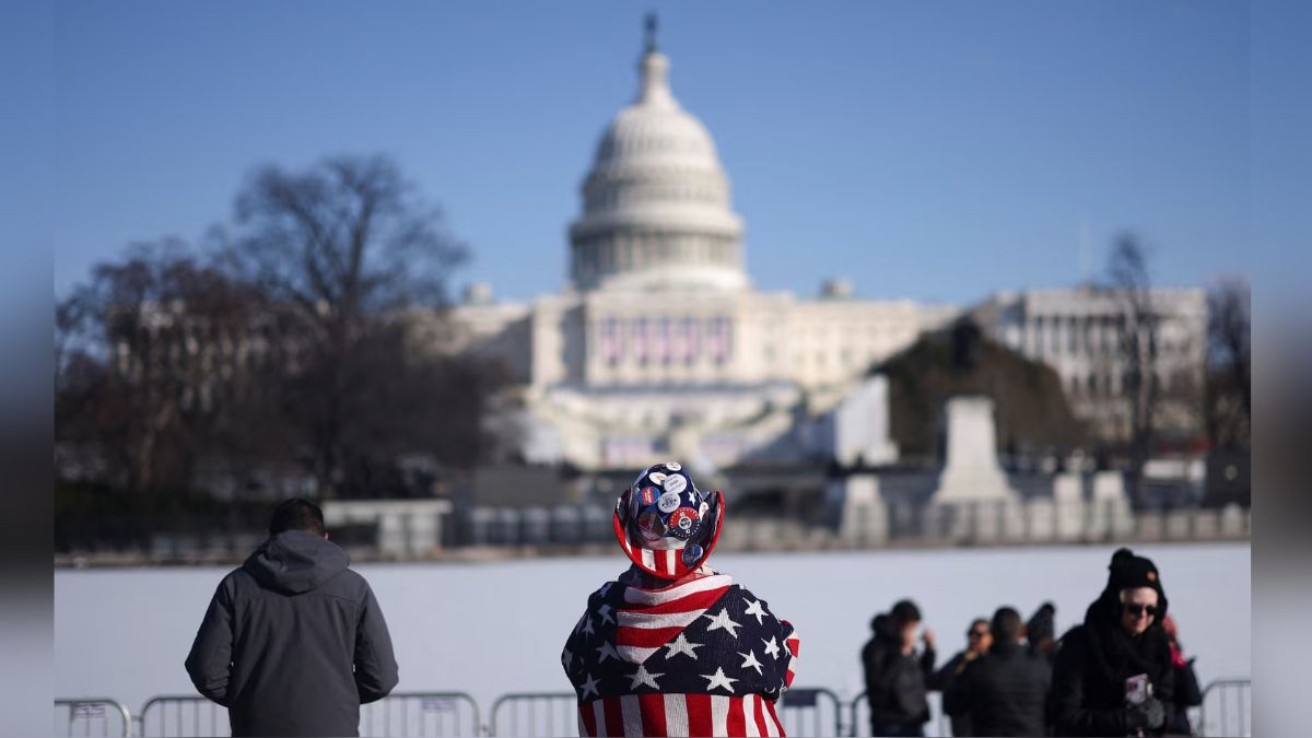 People stand as the U.S. Capitol is seen behind the frozen Capitol reflecting pool. Reuters People stand as the U.S. Capitol is seen behind the frozen Capitol reflecting pool. Reuters