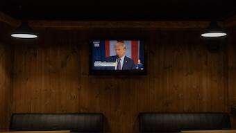 US President Donald Trump is seen on a TV screen during his presidential inauguration, at a restaurant in Kyiv. AFP